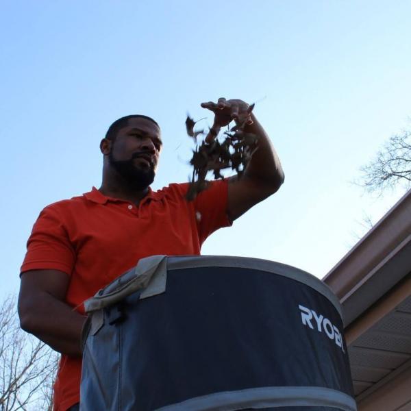 Removing leaves from gutters.